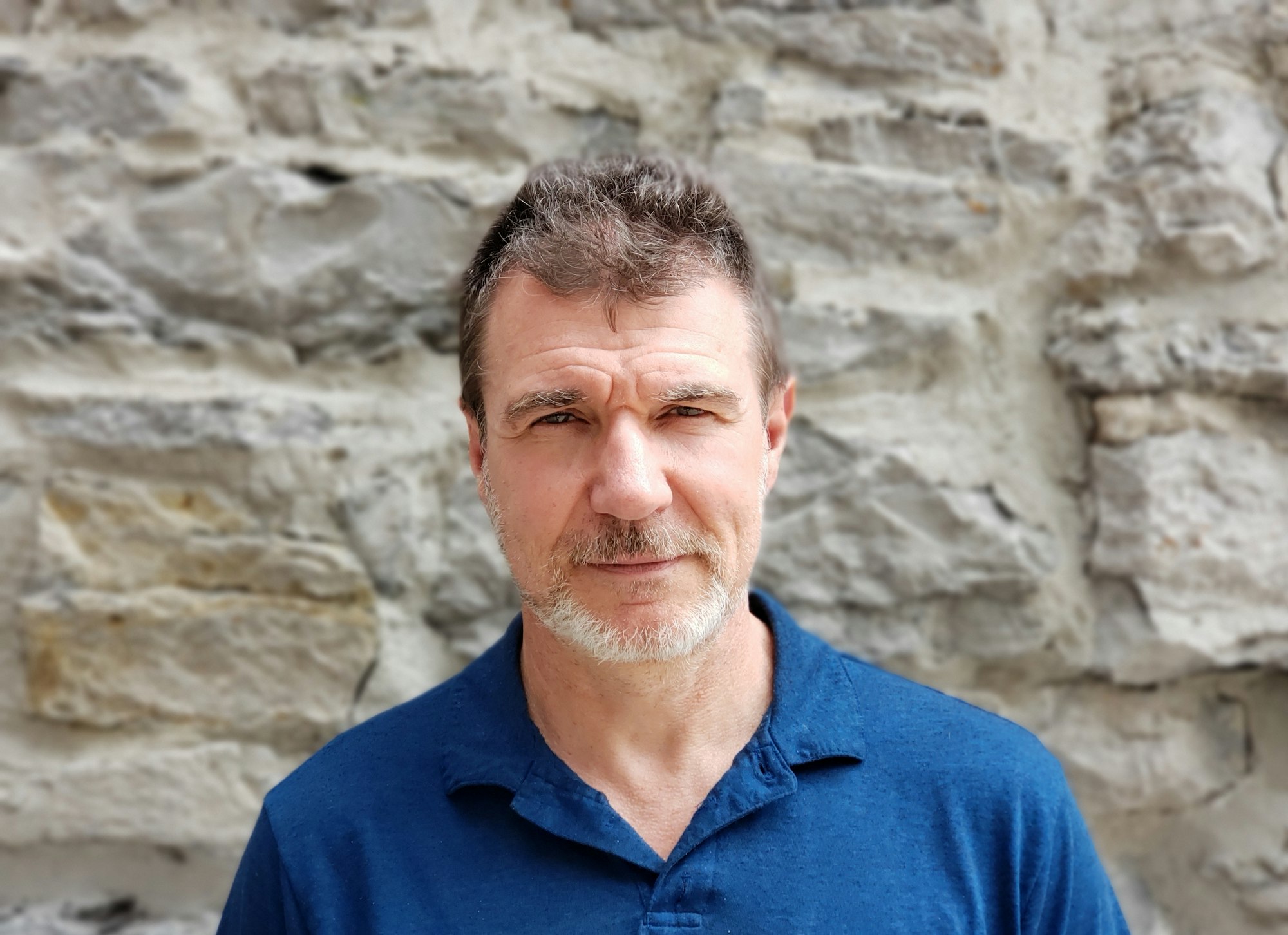 Portrait of a man in late 50s confident and relaxed looking at camera, faces, people