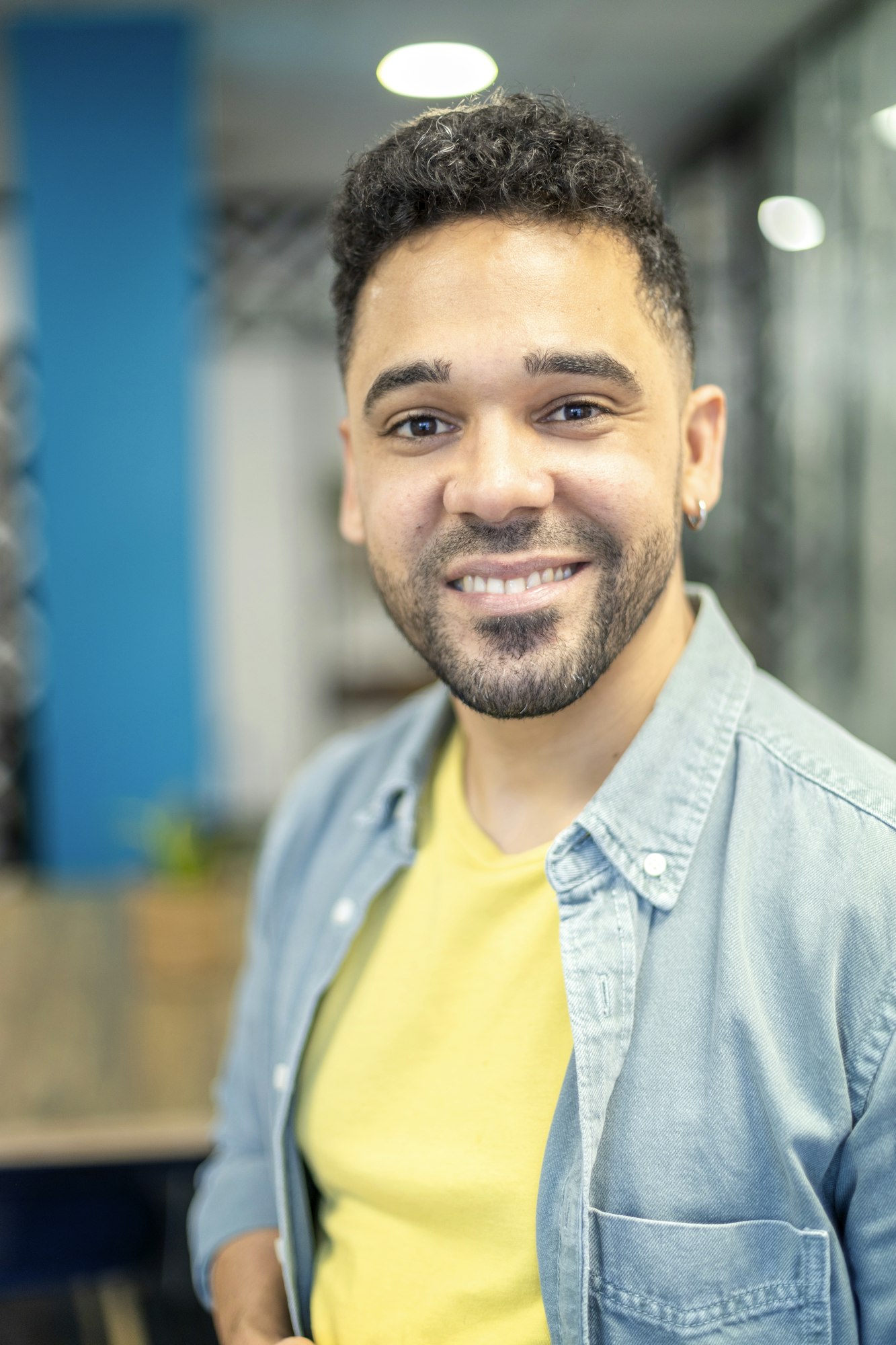 portrait of young latin man smiling indoors